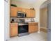 Modern kitchen showcasing stainless steel appliances and light wood cabinetry at 5007 Bellthorn Dr, Orlando, FL 32837