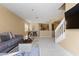 Open-concept living space with tile floors, neutral walls, and seamless flow to dining and kitchen areas offering comfortable living at 5007 Bellthorn Dr, Orlando, FL 32837