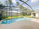 Gorgeous screened-in pool with beautiful green backyard and mature landscaping at 5007 Bellthorn Dr, Orlando, FL 32837