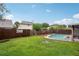 Fenced backyard with an in-ground pool and lush lawn, perfect for outdoor activities and privacy at 520 Starstone Dr, Lake Mary, FL 32746