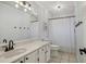 Bathroom with a white vanity, black hardware, and a shower with a decorative curtain at 520 Starstone Dr, Lake Mary, FL 32746