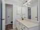 Bathroom featuring a large mirror, neutral colors, and white cabinets with black hardware at 520 Starstone Dr, Lake Mary, FL 32746