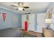 Bedroom featuring light-blue walls, a ceiling fan, and wood-look floors at 520 Starstone Dr, Lake Mary, FL 32746