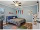 Comfortable bedroom featuring light-blue walls, a ceiling fan, and wood-look floors at 520 Starstone Dr, Lake Mary, FL 32746
