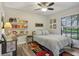 Bright bedroom featuring a large window and shelves filled with books and sports memorabilia at 520 Starstone Dr, Lake Mary, FL 32746