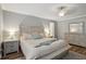 Cozy main bedroom featuring wood-look floors, a ceiling fan, and a decorative headboard at 520 Starstone Dr, Lake Mary, FL 32746