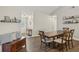 Cozy dining room with wooden table and chairs, plus a charming bench by the entrance at 520 Starstone Dr, Lake Mary, FL 32746