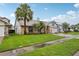 Beautiful front yard featuring lush green grass and mature palm trees enhancing curb appeal at 520 Starstone Dr, Lake Mary, FL 32746