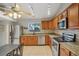 Functional kitchen featuring stainless steel appliances, granite countertops, and tile flooring at 520 Starstone Dr, Lake Mary, FL 32746