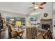 Open-concept living room featuring a brick fireplace and views of the screened lanai and pool at 520 Starstone Dr, Lake Mary, FL 32746