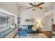 Cozy living room with blue sofa, window seat, and ceiling fan, perfect for relaxing and entertaining at 520 Starstone Dr, Lake Mary, FL 32746