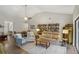 Bright living room featuring vaulted ceiling, bookshelf, and an open dining area at 520 Starstone Dr, Lake Mary, FL 32746