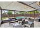 Screened-in patio with comfortable seating, string lights, and views of the backyard and pool at 520 Starstone Dr, Lake Mary, FL 32746