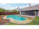 Enjoy a backyard with a sparkling in-ground pool surrounded by a lush lawn and mature trees at 520 Starstone Dr, Lake Mary, FL 32746