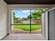 Enclosed back porch showcasing a serene view of the lush backyard at 600 Northern Way # 103, Winter Springs, FL 32708