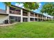Back of home highlighting private screened patios and well-manicured lawn at 600 Northern Way # 103, Winter Springs, FL 32708