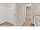 Hallway leading to updated bathroom with granite countertop, walk-in closet with shelving at 600 Northern Way # 103, Winter Springs, FL 32708