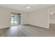 Airy bedroom with wood-look floors and sliding glass doors to the patio at 600 Northern Way # 103, Winter Springs, FL 32708