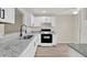Contemporary kitchen with granite counters, stainless steel sink, and modern appliances at 600 Northern Way # 103, Winter Springs, FL 32708