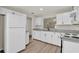 Clean, updated kitchen featuring new cabinets, granite countertops and wood-look flooring at 600 Northern Way # 103, Winter Springs, FL 32708