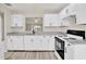 Bright kitchen featuring white cabinets, granite countertops, and stainless appliances at 600 Northern Way # 103, Winter Springs, FL 32708