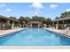 Community pool with lounge chairs and central cabana at 600 Northern Way # 103, Winter Springs, FL 32708