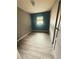 This bedroom offers durable wood-look tile flooring and a serene atmosphere with natural light from a window at 605 Pleasantdale Dr, Wildwood, FL 34785