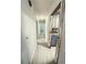 Hallway with new wood-look floors, leading to various rooms, including a glimpse of the kitchen at 605 Pleasantdale Dr, Wildwood, FL 34785