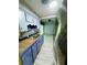 Galley kitchen featuring updated cabinets, stainless steel appliances, and tile backsplash at 605 Pleasantdale Dr, Wildwood, FL 34785