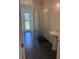 Bright bathroom with glass shower, pedestal sink, and door to outside at 6125 Village Edge Pl, Sanford, FL 32771
