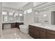 Elegant bathroom featuring double vanity, soaking tub, and large mirrors providing ample natural light at 6125 Village Edge Pl, Sanford, FL 32771