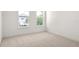 Spacious bedroom with plush neutral carpet and two windows at 6125 Village Edge Pl, Sanford, FL 32771
