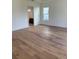 Spacious bedroom with pristine hardwood floors and a bright window at 6125 Village Edge Pl, Sanford, FL 32771