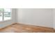 Corner bedroom with hardwood floors, white trim, and a large window for natural light at 6125 Village Edge Pl, Sanford, FL 32771