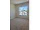 Bedroom with a large window overlooking the neighborhood at 6125 Village Edge Pl, Sanford, FL 32771