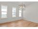 Bright dining room with hardwood floors, modern light fixture, and large windows for natural light at 6125 Village Edge Pl, Sanford, FL 32771