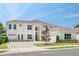 Stunning two-story home featuring a brick driveway, manicured lawn, and a neutral color palette at 6125 Village Edge Pl, Sanford, FL 32771