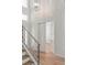 Staircase and entry featuring hardwood floors, decorative wall paneling, and contemporary lighting at 6125 Village Edge Pl, Sanford, FL 32771