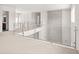 Bright hallway with glass railing and plush carpeting at 6125 Village Edge Pl, Sanford, FL 32771