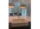 Kitchen view shows a large sink, stainless steel faucet, pendant lighting, and living room at 6125 Village Edge Pl, Sanford, FL 32771