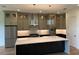 Modern kitchen features a large island, stainless steel appliances, and pendant lighting above the island at 6125 Village Edge Pl, Sanford, FL 32771