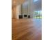 Bright living room featuring hardwood floors, a fireplace, and sliding glass doors to the yard at 6125 Village Edge Pl, Sanford, FL 32771