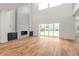Bright living room boasts a grand fireplace, wood flooring, and large sliding doors at 6125 Village Edge Pl, Sanford, FL 32771