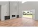 Spacious living room has a gray tiled fireplace, wood floors, and large sliding glass doors at 6125 Village Edge Pl, Sanford, FL 32771