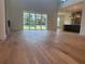 Open-concept living room with hardwood floors, a fireplace, and view of backyard at 6125 Village Edge Pl, Sanford, FL 32771