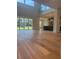 Open-concept living room with hardwood floors, abundant natural light, and views of the backyard at 6125 Village Edge Pl, Sanford, FL 32771