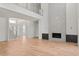 Bright living room with a fireplace, hardwood floors, and staircase to a loft at 6125 Village Edge Pl, Sanford, FL 32771