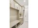 Well-organized mudroom with built-in bench, storage cubbies, and stylish cabinetry at 6125 Village Edge Pl, Sanford, FL 32771