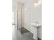 Modern shower featuring a glass enclosure, decorative wall tiles, and pedestal sink at 6125 Village Edge Pl, Sanford, FL 32771