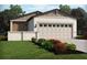 Charming single-story home with stone accents, neutral tones, and a well-manicured lawn with colorful plantings at 674 Pennywort St, Lake Alfred, FL 33850